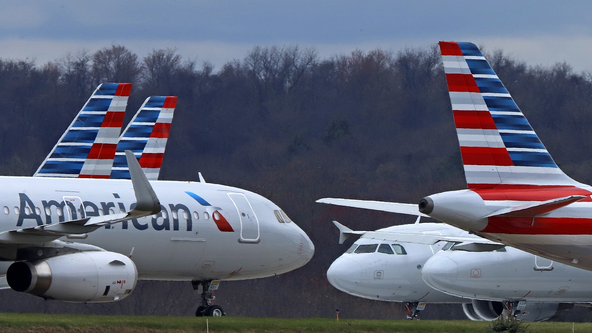 FILE - American Airlines planes sit stored at Pittsburgh International Airport on March 31, 2020, in Imperial, Pa. Federal officials said Wednesday Jan. 4, 2023, that American Airlines retaliated against flight attendants who complained about jet fuel fumes seeping into airplane cabins. (AP Photo/Gene J. Puskar, File)