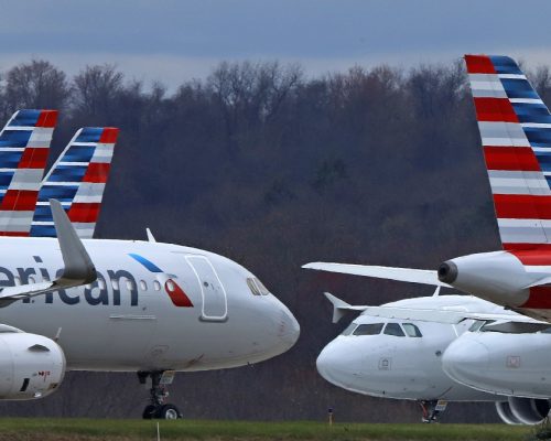 FILE - American Airlines planes sit stored at Pittsburgh International Airport on March 31, 2020, in Imperial, Pa. Federal officials said Wednesday Jan. 4, 2023, that American Airlines retaliated against flight attendants who complained about jet fuel fumes seeping into airplane cabins. (AP Photo/Gene J. Puskar, File)